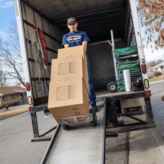 man unloading boxes from truck.