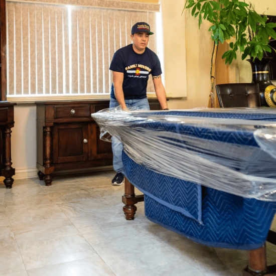 movers wrapping large furniture.